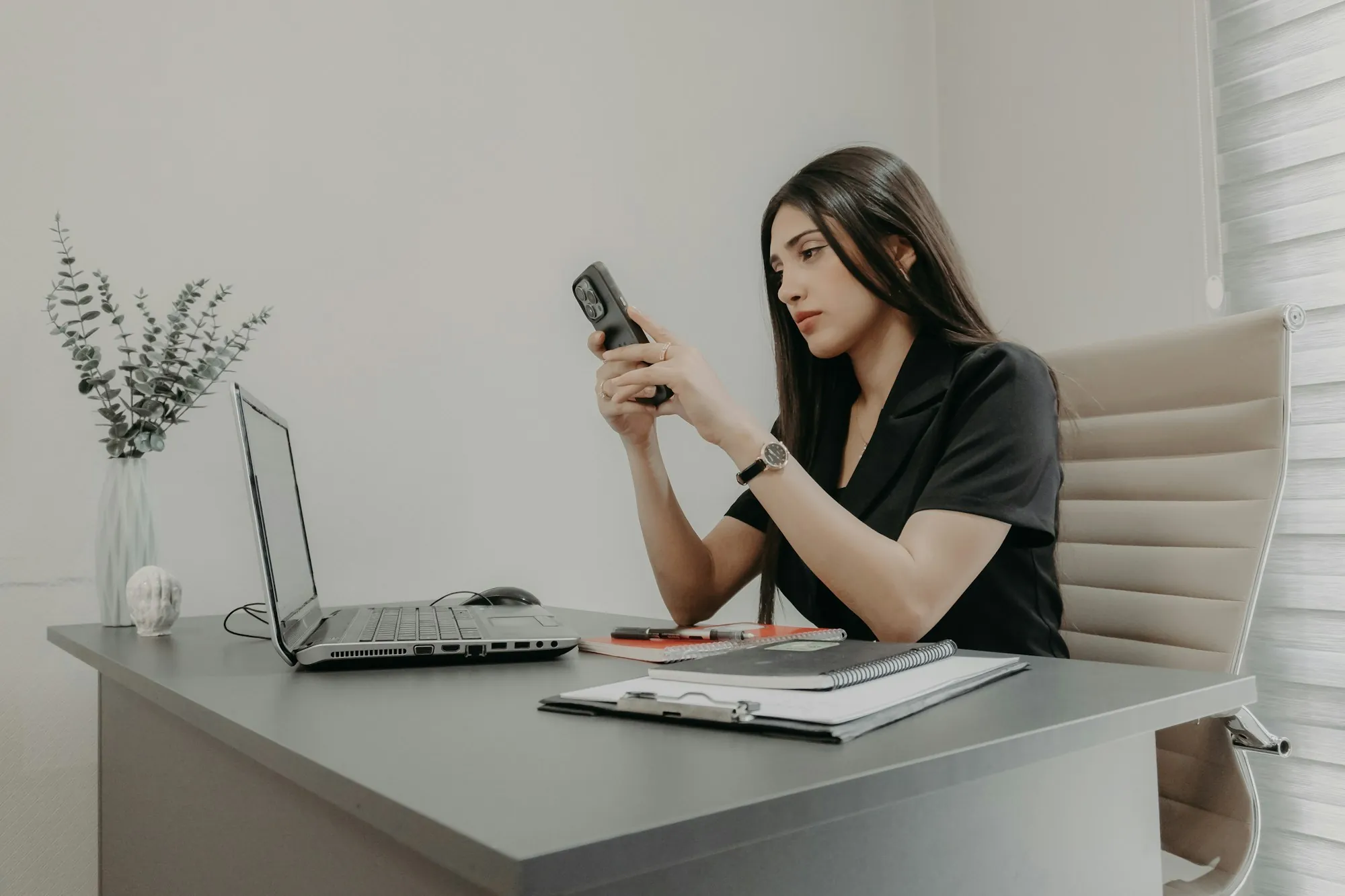 A woman on the telephone at a desk